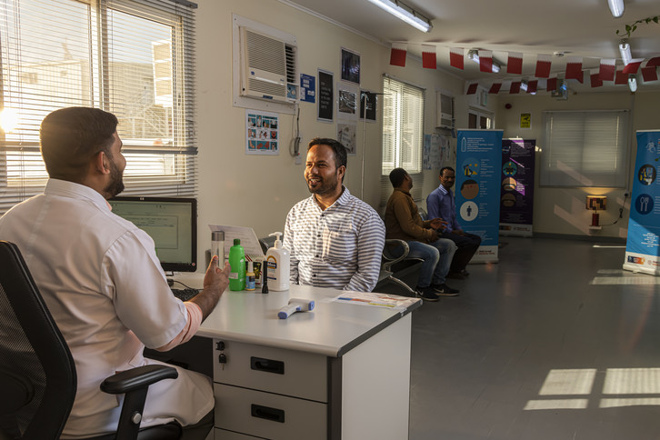 Worker undergoing comprehensive medical screening at Lusail Stadium site clinic