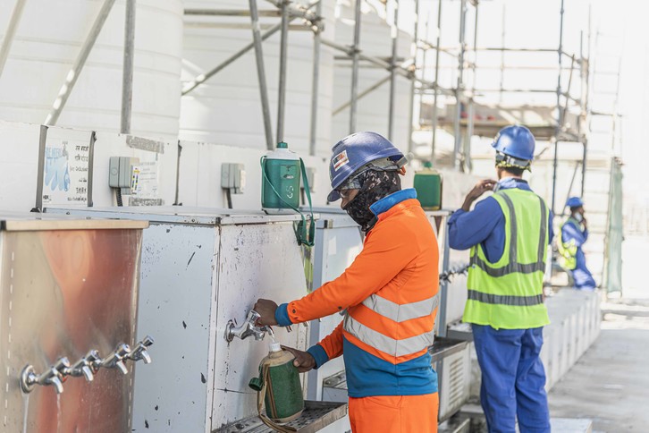 Workers accessing cold water stations at the Lusail Stadium construction site 