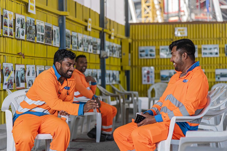 Workers sitting in a rest area at the Lusail Stadium construction site